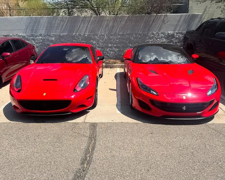 Red Ferrari California and Ferrari Portofino parked side by side, seen head-on