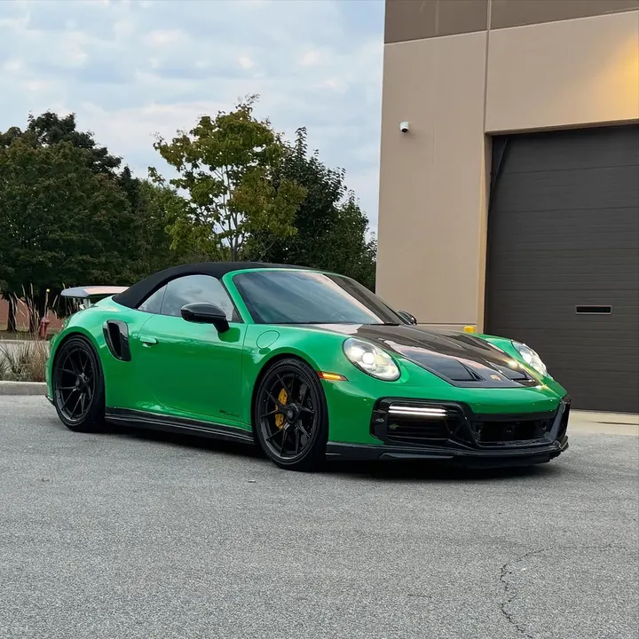 Green Porsche 911 Turbo S Cabriolet (992) with a carbon hood and black soft top