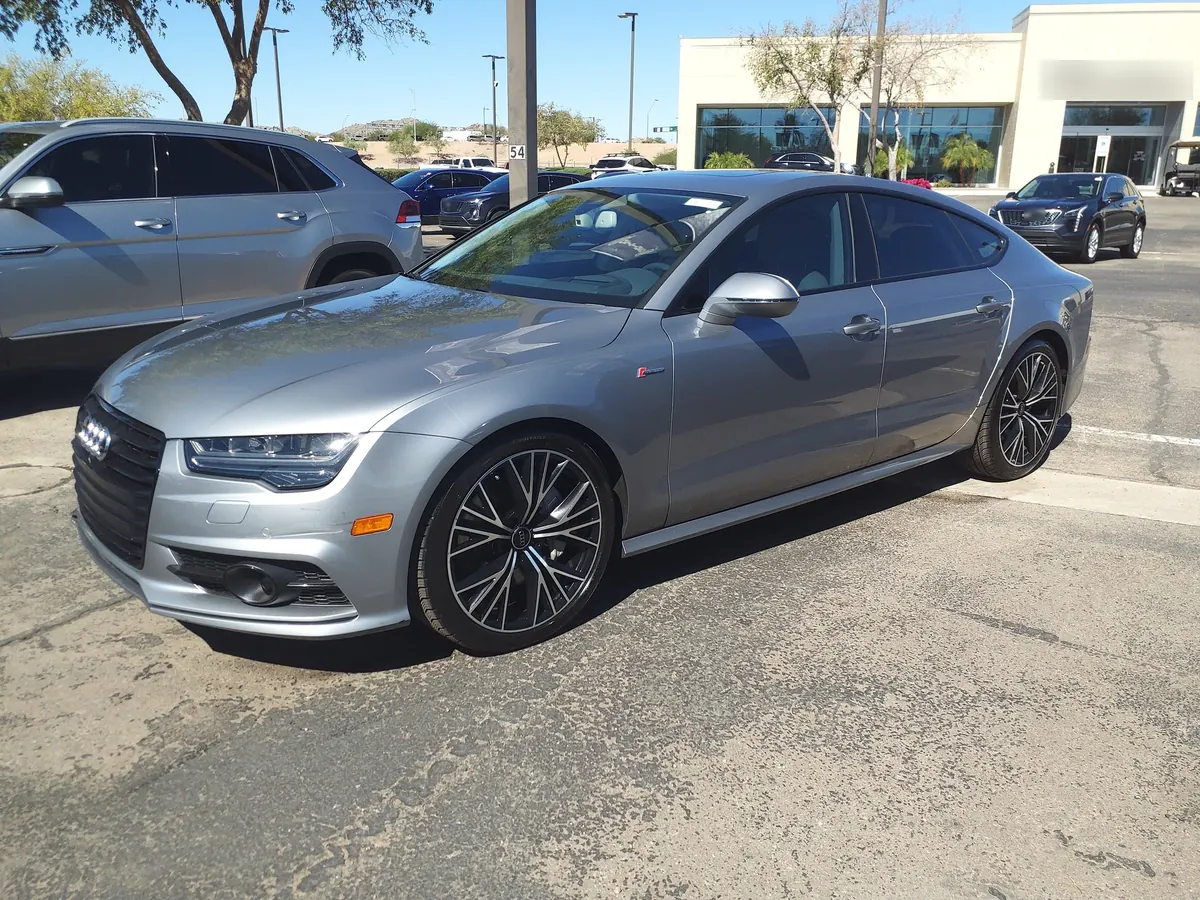 Front three-quarter view of a silver Audi RS 7 (C7) Sportback in a parking lot