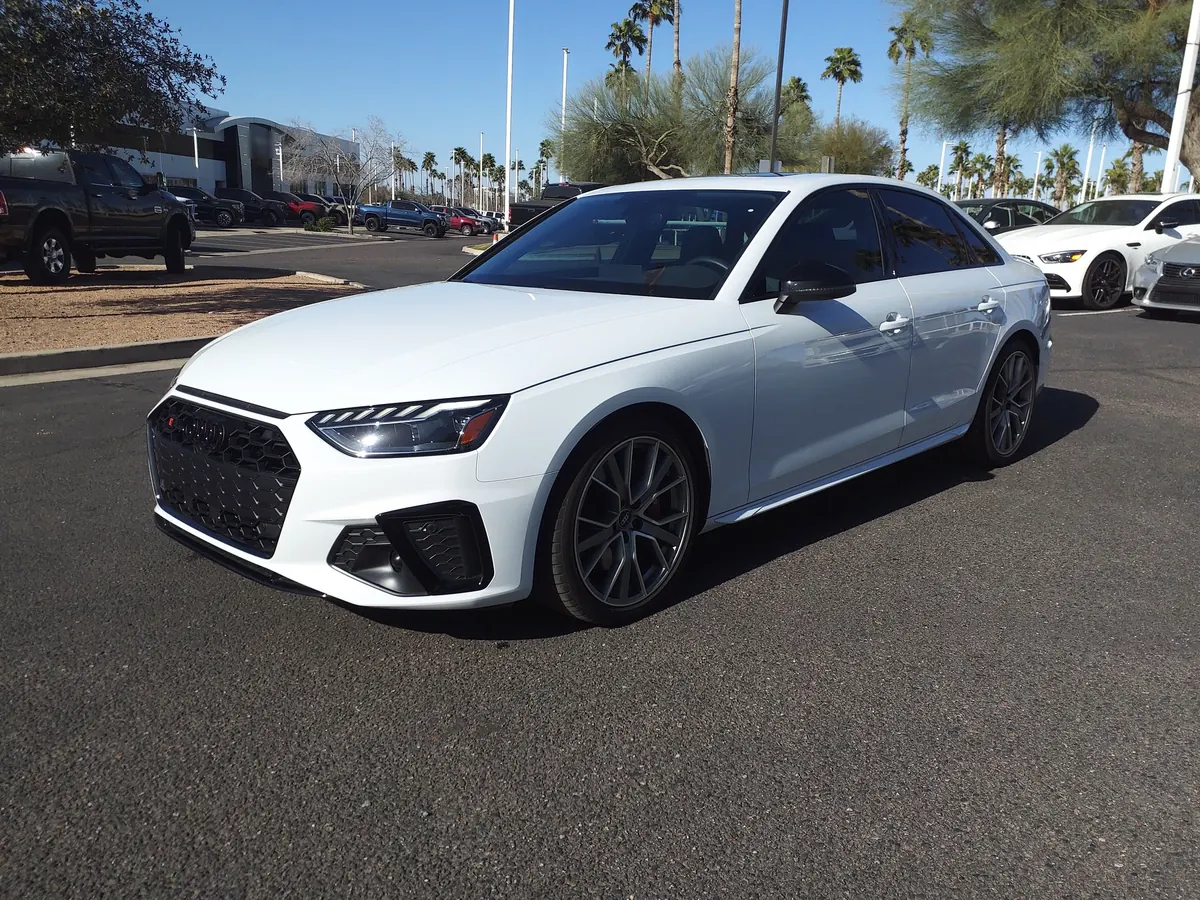 Front three-quarter view of a white Audi S4 (B9) sedan in a parking lot
