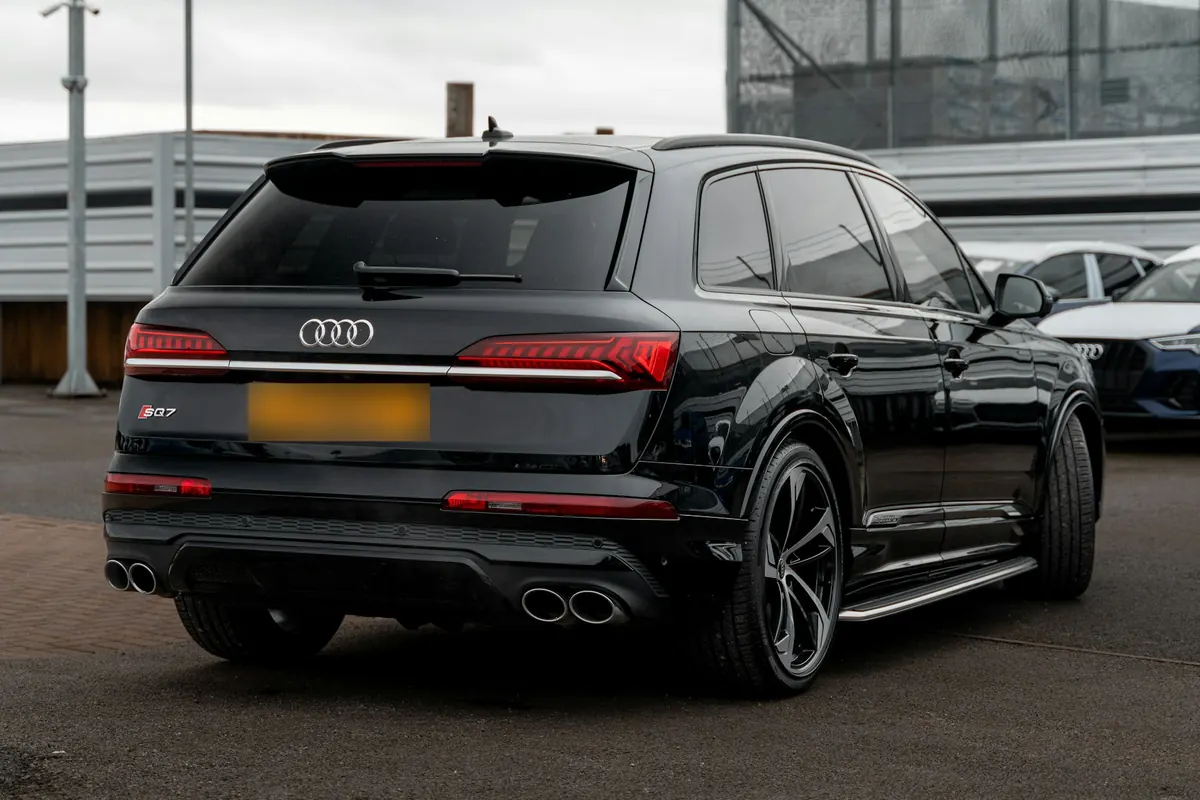 Rear three-quarter view of a black Audi SQ7 in a parking lot