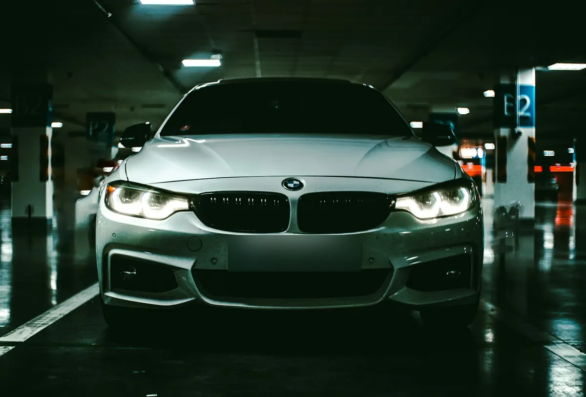 Front view of a silver BMW 440i (F32) in a parking garage