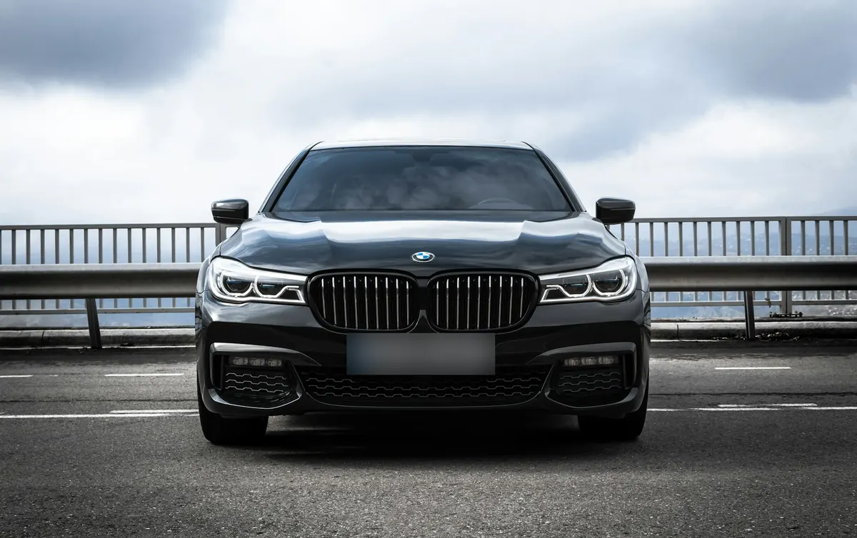 Front view of a black BMW 750i (G11) on a mountain road