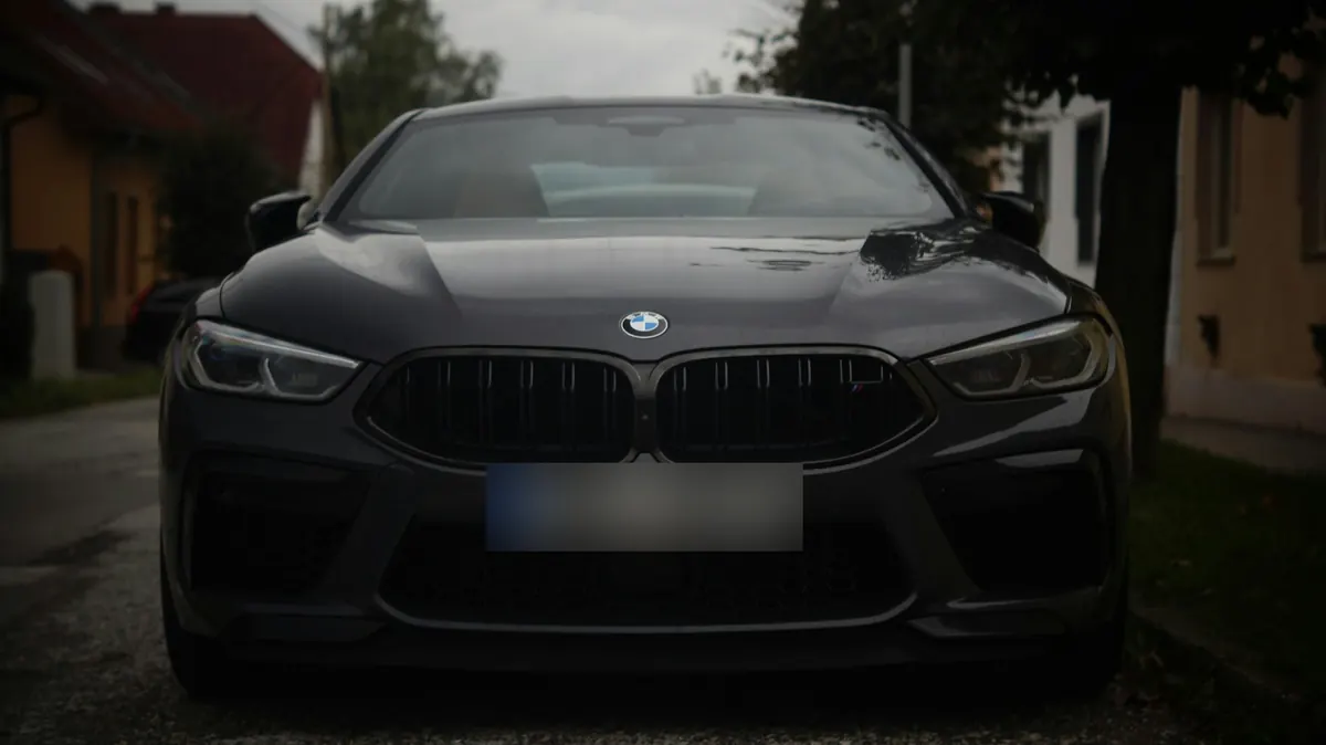Front view of a dark grey BMW M8 Competition (F91 / F92 / F93) parked on a village street