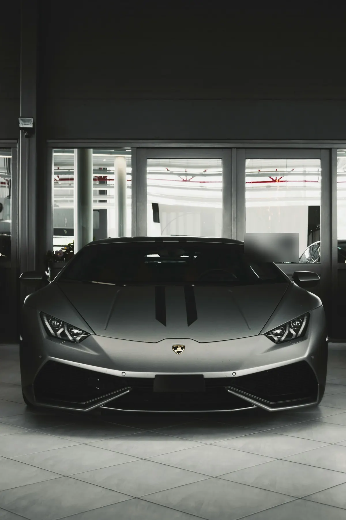Front view of a grey Lamborghini Huracán LP 580-2 in a showroom