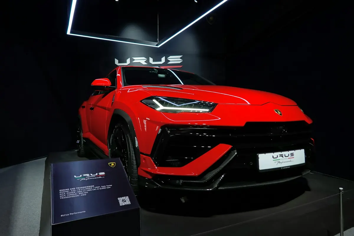 Front three-quarter view of a red Lamborghini Urus Performante on a display stand