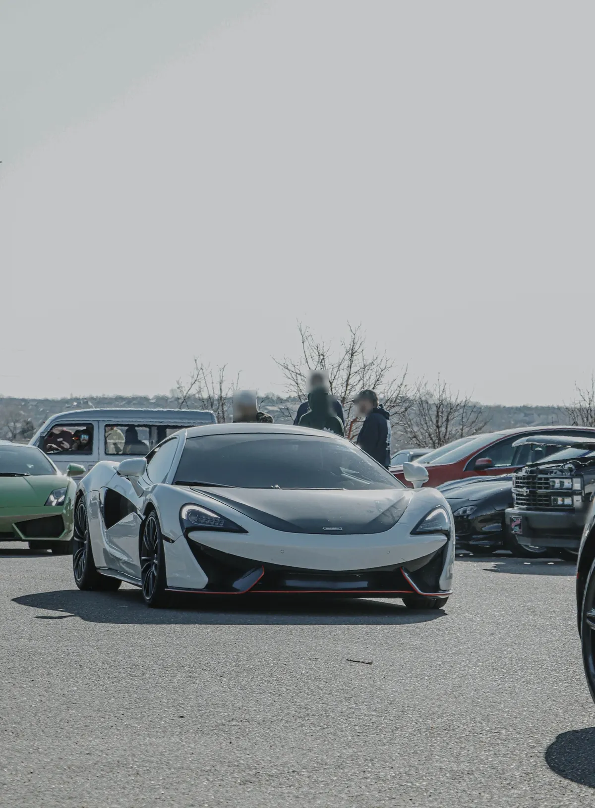 Front view of a white McLaren 540C at a car meet
