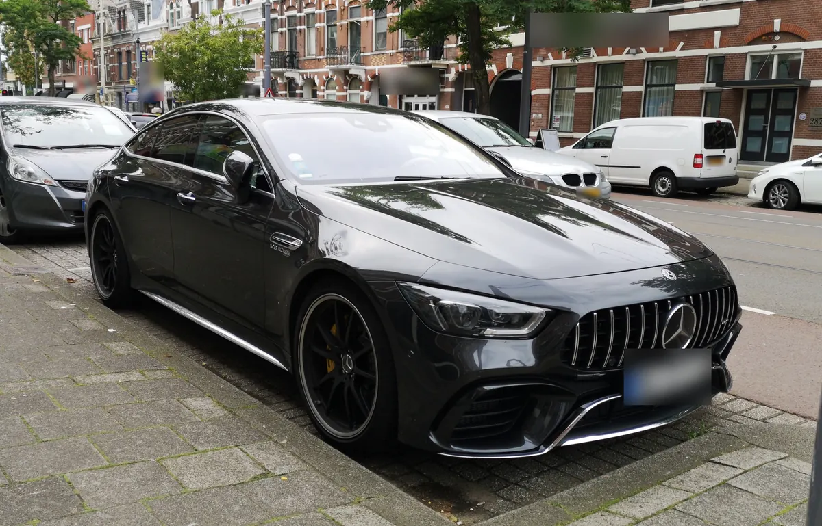 Front three-quarter view of a dark grey Mercedes-AMG GT 63 S 4-Door Coupé (X290) parked on a city street