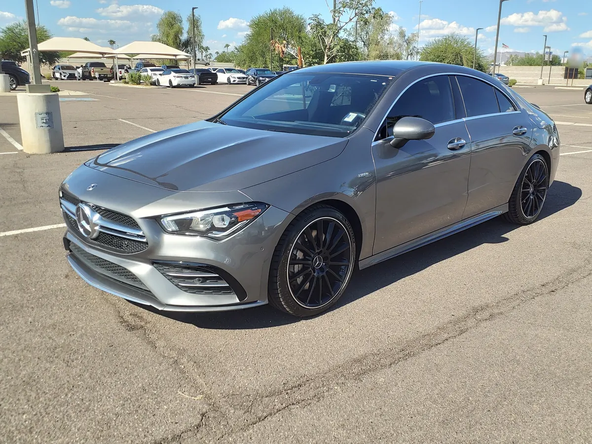Front three-quarter view of a grey Mercedes-AMG CLA35 (C118) in a parking lot