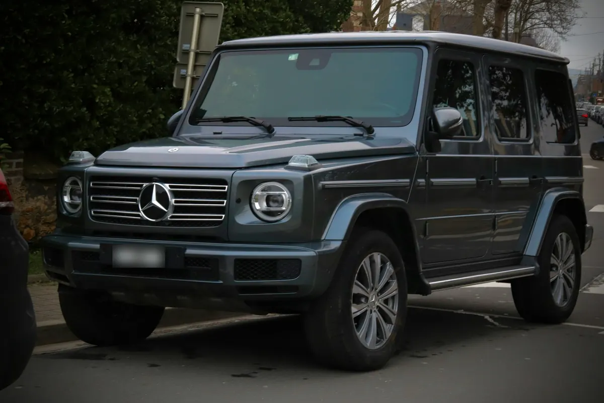 Front three-quarter view of a grey Mercedes-Benz G550 (W463A) parked on a street