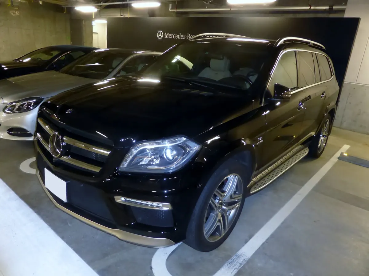 Front three-quarter view of a black Mercedes-AMG GL63 (X166) in a parking garage