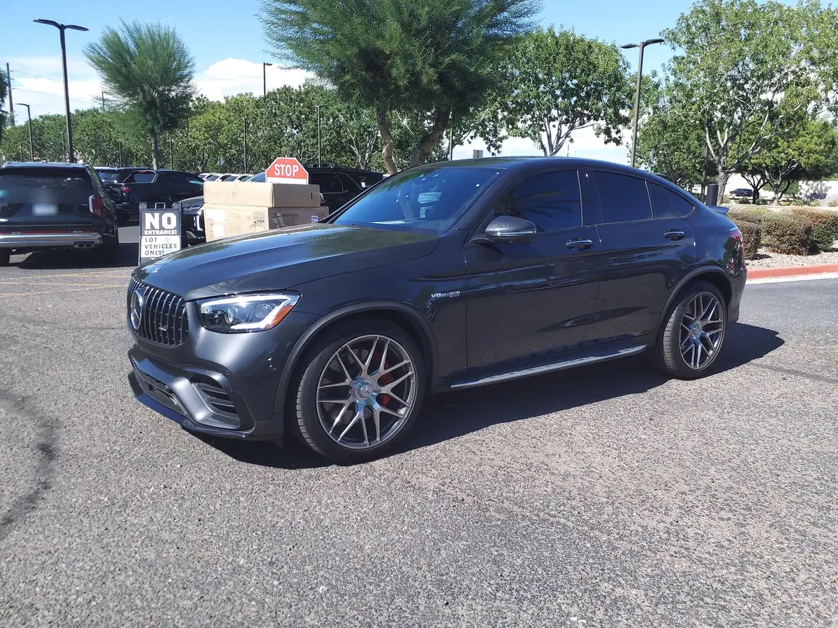 Front three-quarter view of a dark grey Mercedes-AMG GLC43 Coupe (C253) in a parking lot