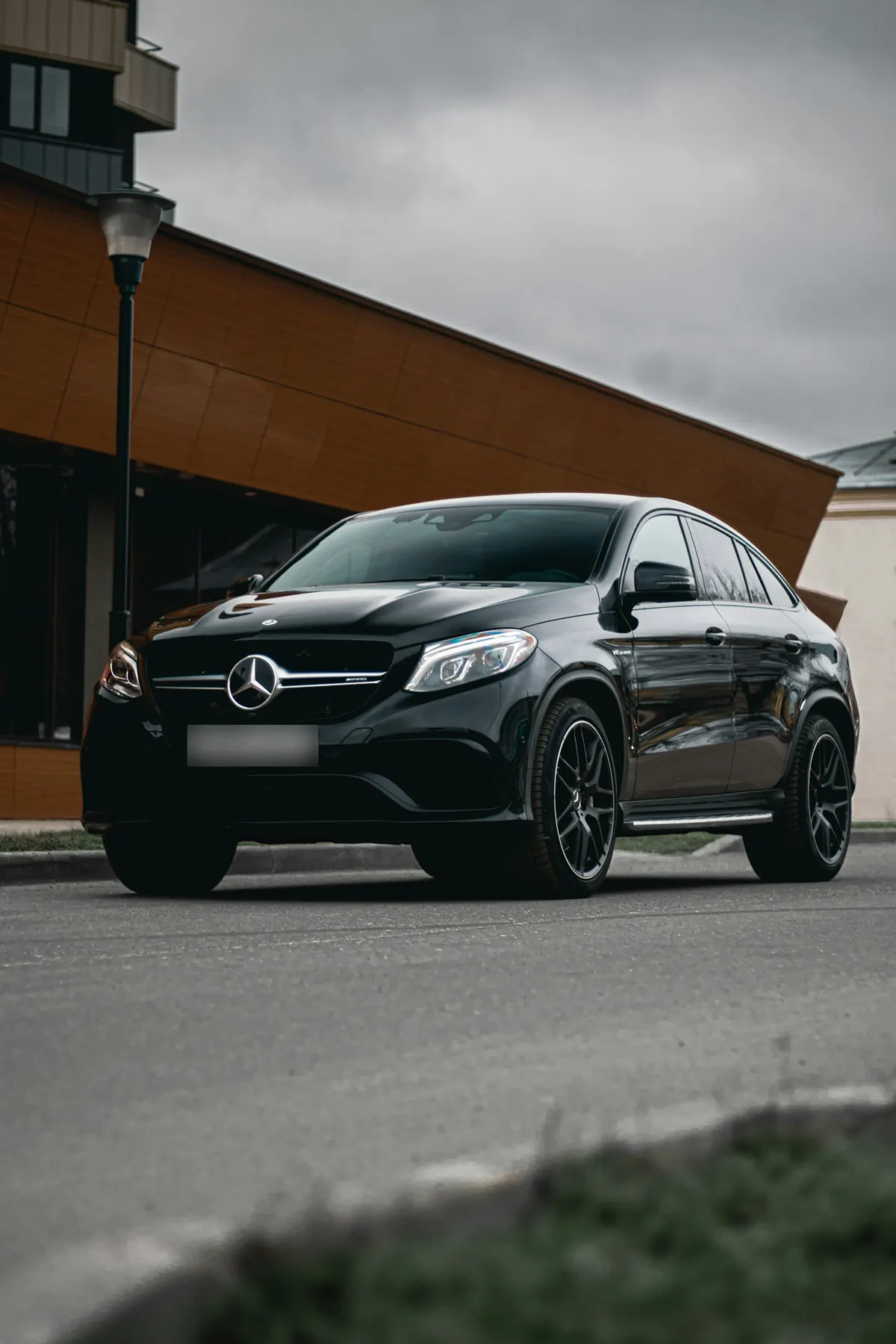 Front three-quarter view of a black Mercedes-Benz GLE450 Coupe (C292) on a street