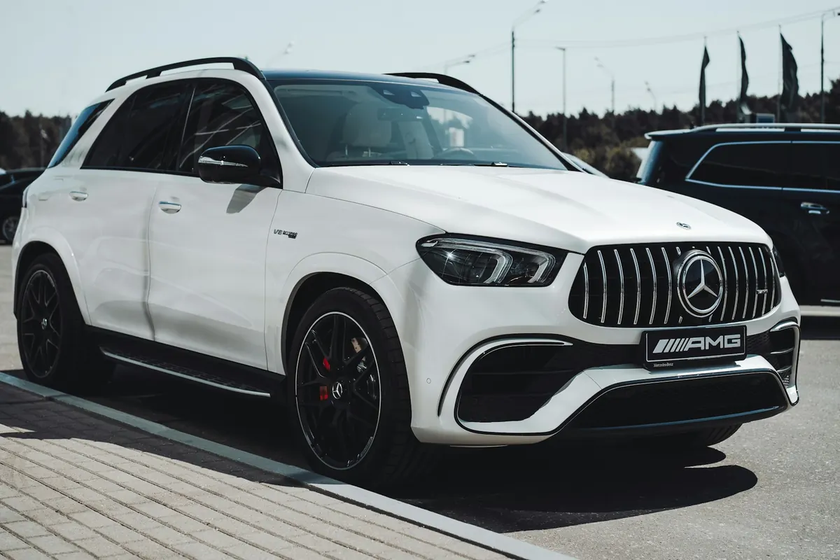 Front three-quarter view of a white Mercedes-AMG GLE63 SUV (V167) at a dealership