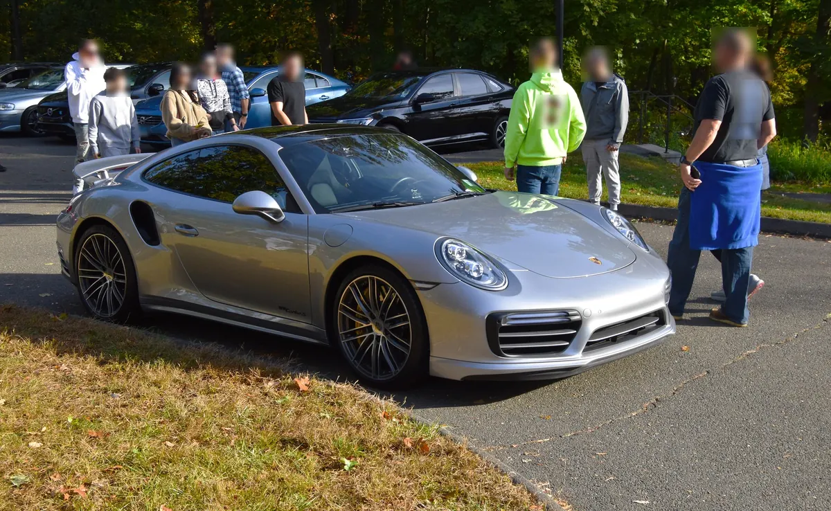 Front three-quarter view of a silver Porsche 911 Turbo S Exclusive Series (991.2) at a car meet
