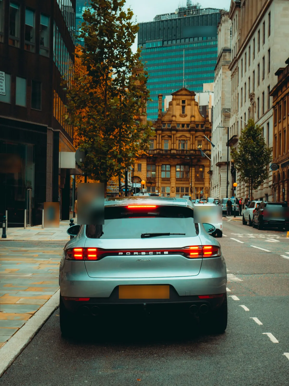 Rear view of a silver Porsche Macan (95B.2) on a city street