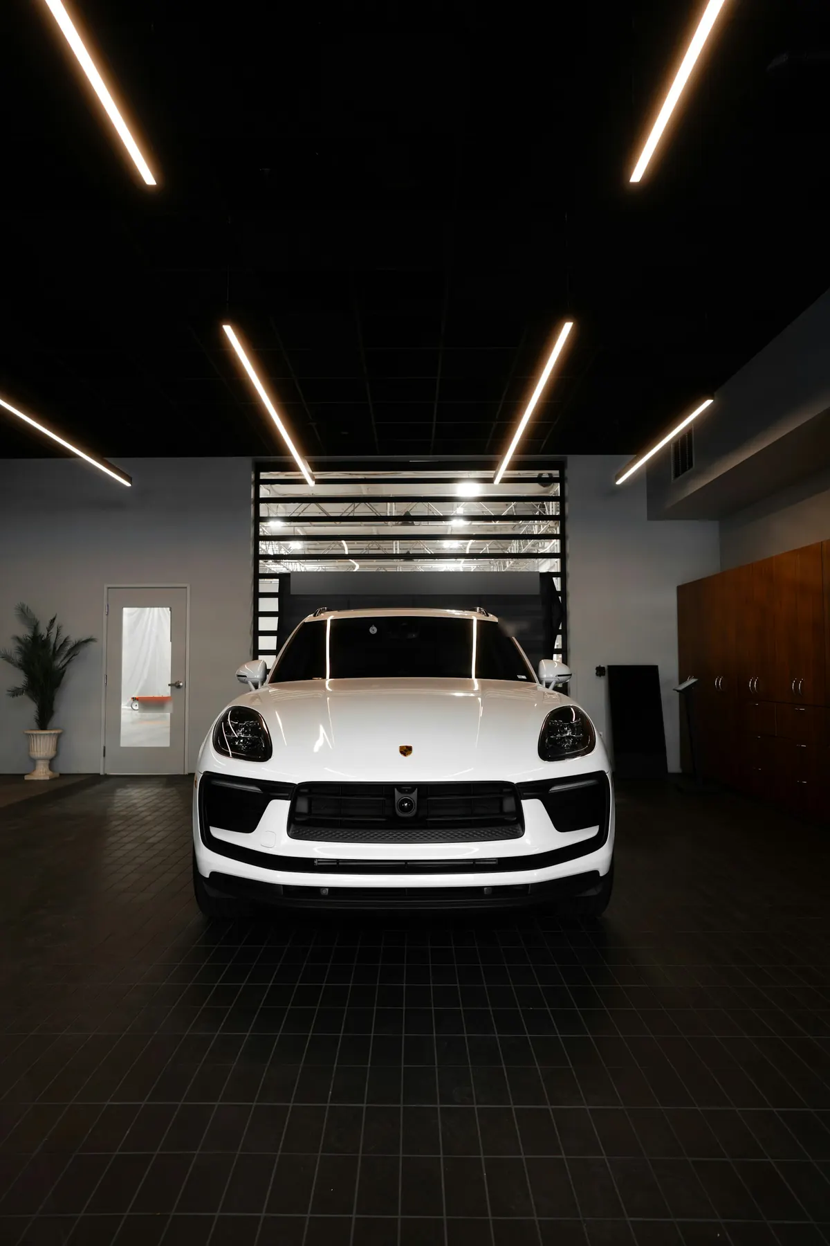 Front view of a white Porsche Macan GTS (95B.3) in a showroom