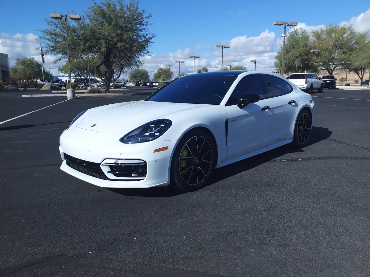 Front three-quarter view of a white Porsche Panamera 4S E-Hybrid (971.2) in a parking lot