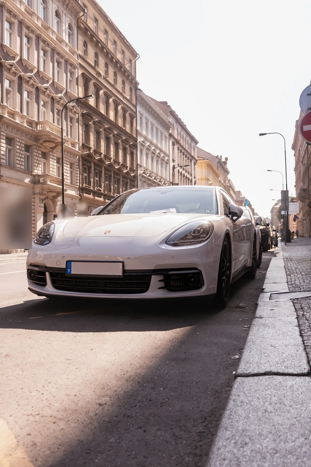 Front view of a white Porsche Panamera (971.1) parked on a city street