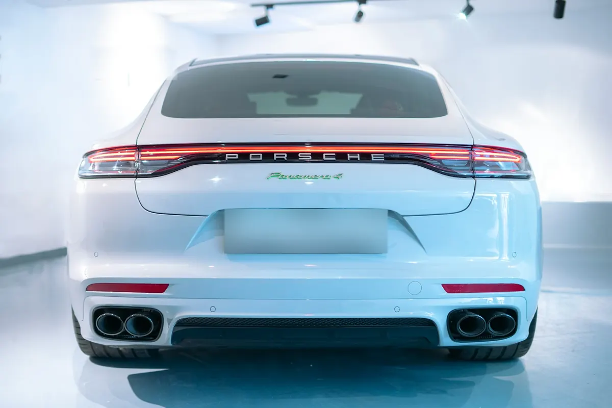 Rear view of a white Porsche Panamera 4 E-Hybrid (971.2) in a studio