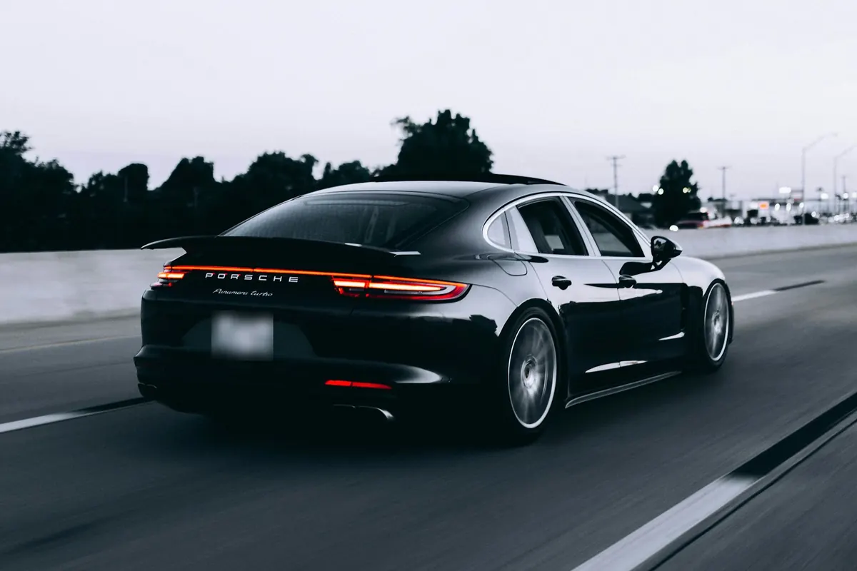 Rear three-quarter view of a black Porsche Panamera Turbo (971.1) on a highway