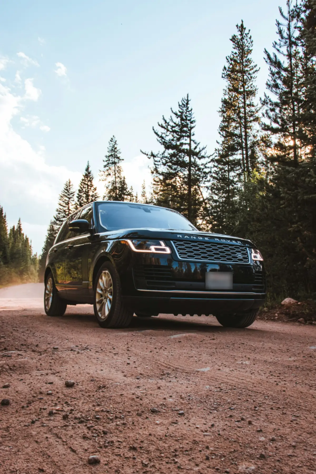 Front three-quarter view of a black Range Rover P525 Supercharged V8 (L405) on a dirt forest road