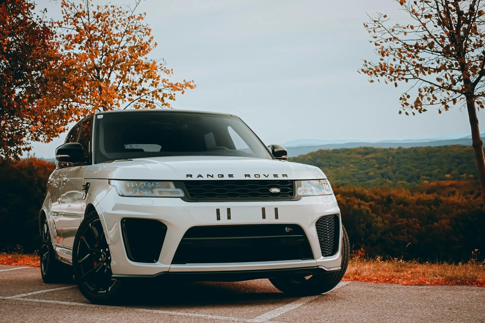 White Range Rover Sport SVR at an autumn overlook